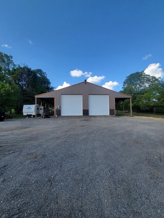 view of side of home featuring a carport and a garage