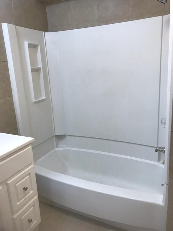 bathroom featuring vanity and bathing tub / shower combination