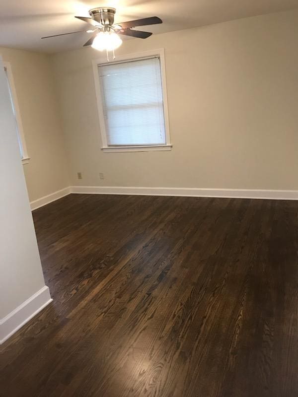 spare room with ceiling fan and dark hardwood / wood-style flooring