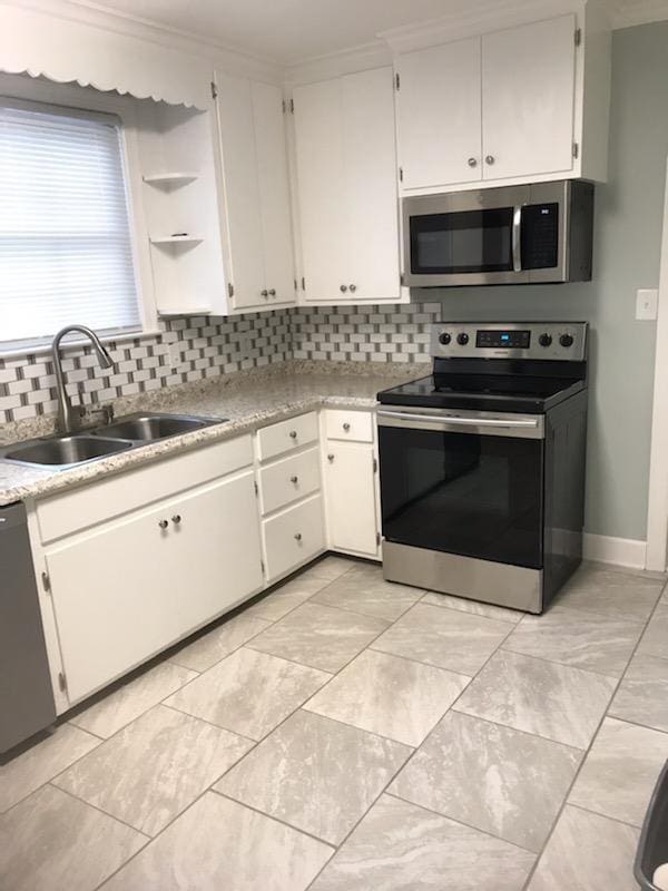 kitchen with sink, light tile flooring, and stainless steel appliances