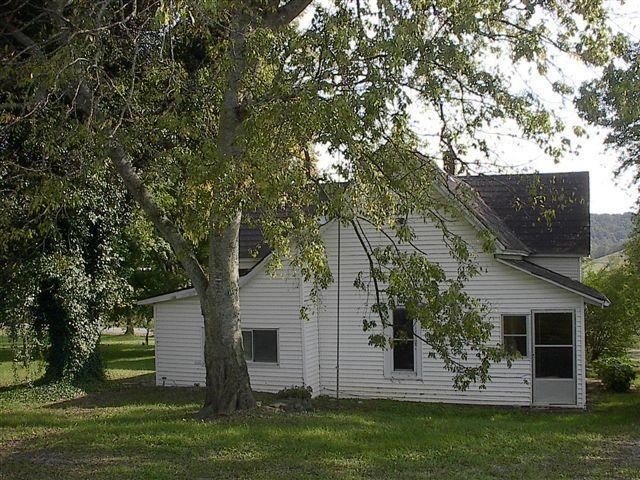 back of property featuring a yard