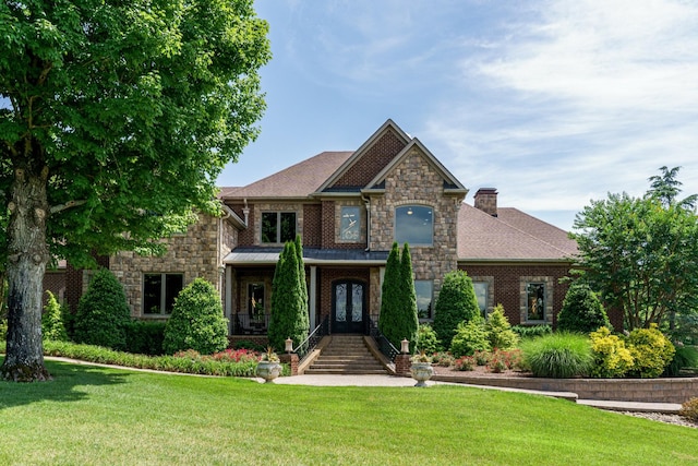 view of front of home featuring a front lawn and french doors