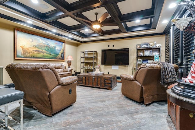 living room featuring ornamental molding, coffered ceiling, ceiling fan, and beamed ceiling