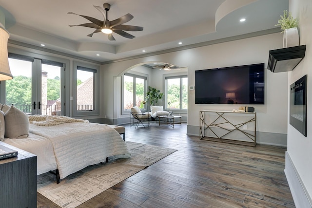 bedroom with ceiling fan, french doors, a tray ceiling, access to outside, and dark hardwood / wood-style floors