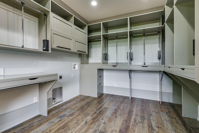 walk in closet with dark hardwood / wood-style flooring