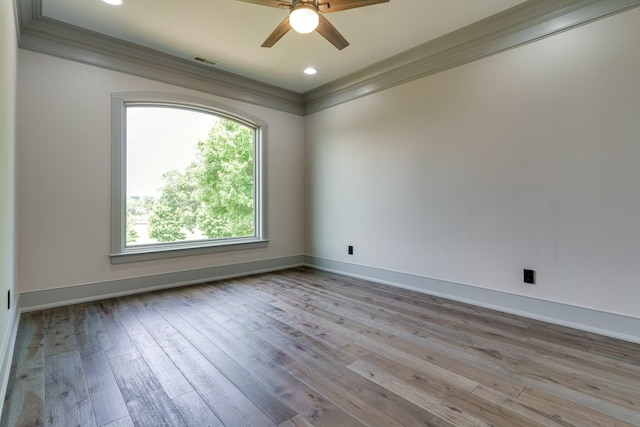 unfurnished room with crown molding, light hardwood / wood-style floors, and ceiling fan