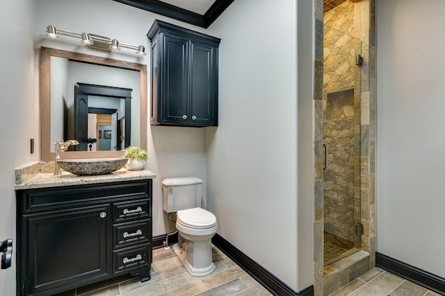 bathroom with toilet, a shower with door, vanity, ornamental molding, and tile floors