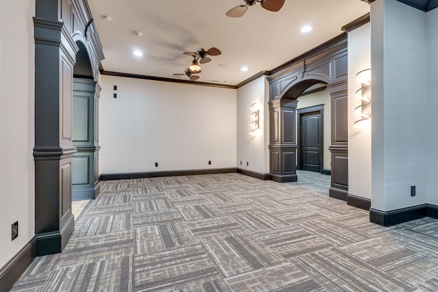 interior space featuring crown molding, ceiling fan, carpet flooring, and ornate columns