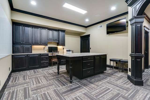 carpeted office featuring crown molding and ornate columns