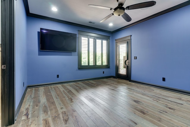 spare room featuring ceiling fan, ornamental molding, and light hardwood / wood-style floors