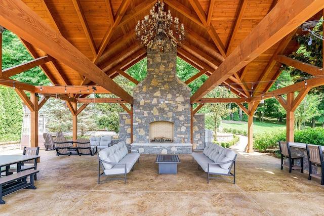 view of terrace with a gazebo and an outdoor living space with a fireplace