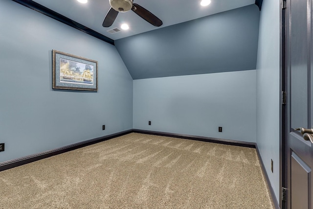 spare room with ceiling fan, lofted ceiling, and carpet floors