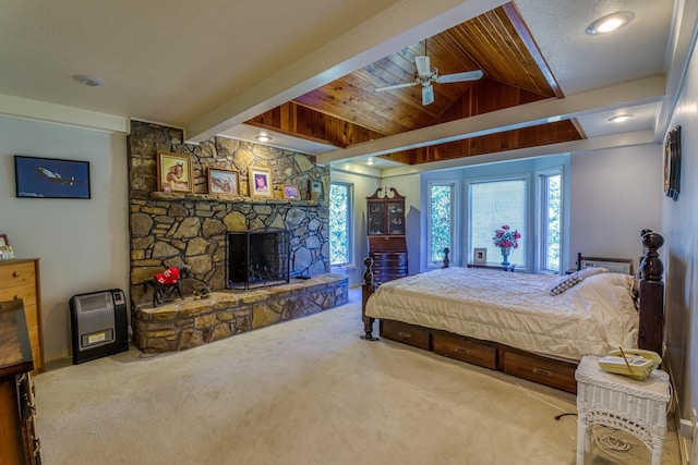 carpeted bedroom with a stone fireplace, ceiling fan, wooden ceiling, and vaulted ceiling with beams