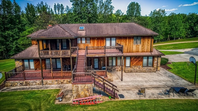 back of property featuring a yard and a patio