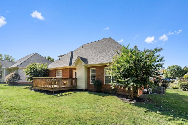 back of property with a deck, central AC, and a yard