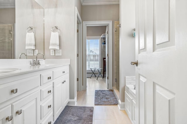 bathroom featuring tile flooring, ornamental molding, an enclosed shower, and dual bowl vanity