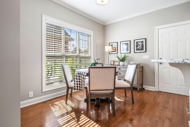 dining room with crown molding and dark wood-type flooring