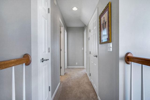 hallway with light colored carpet