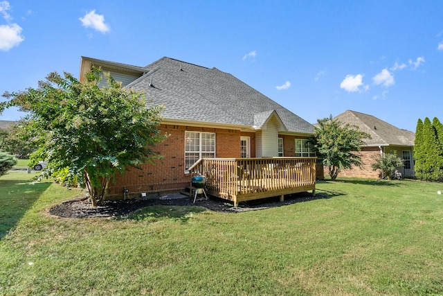 back of property with a deck and a lawn