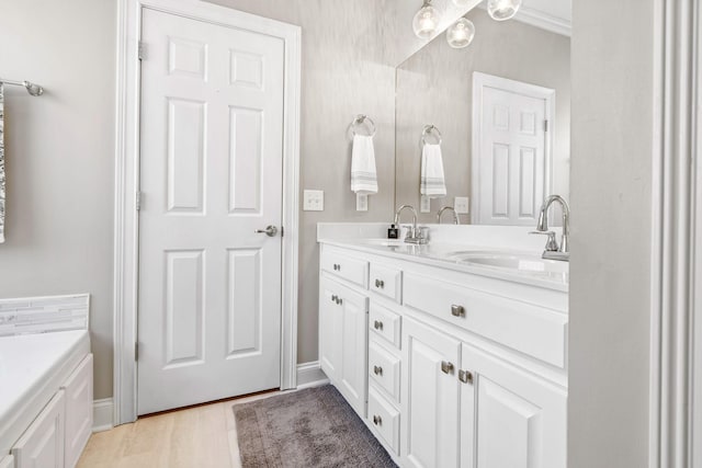 bathroom featuring hardwood / wood-style floors and dual vanity