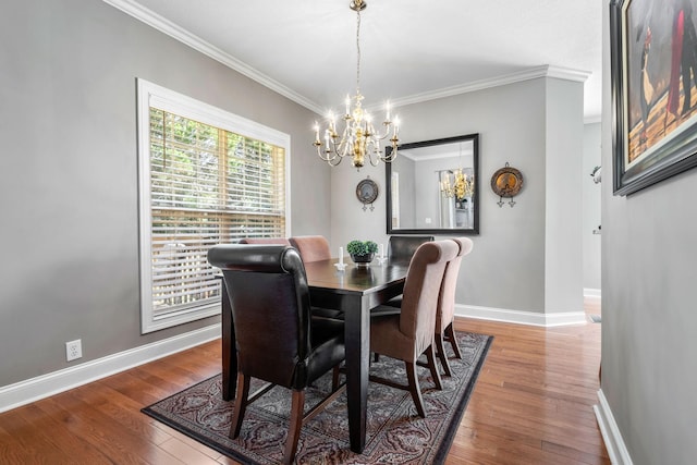 dining area featuring dark hardwood / wood-style floors, ornamental molding, and a notable chandelier