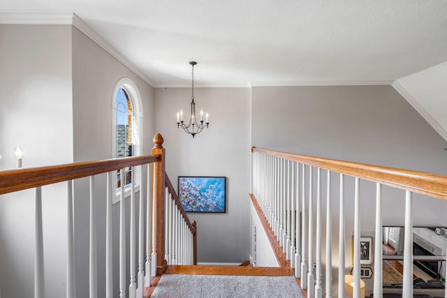 stairs with an inviting chandelier, ornamental molding, and wood-type flooring