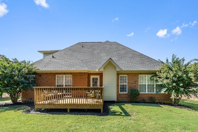 back of house featuring a wooden deck and a lawn