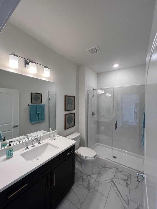 bathroom featuring an enclosed shower, vanity, and toilet