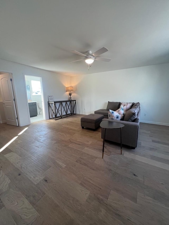 living room with ceiling fan and wood-type flooring