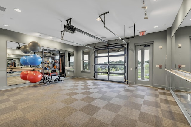 interior space with visible vents, baseboards, recessed lighting, and a garage door opener