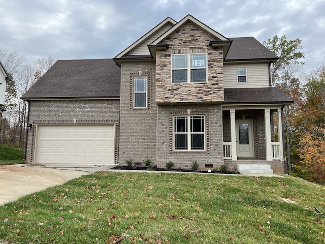 view of front of home featuring covered porch, a front yard, and a garage