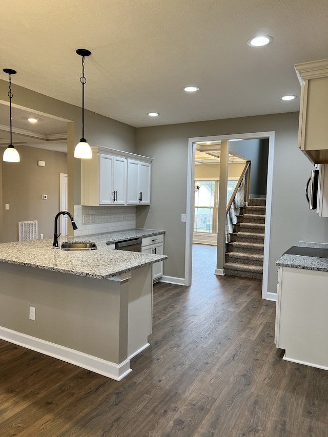 kitchen featuring sink, tasteful backsplash, dark hardwood / wood-style flooring, and pendant lighting