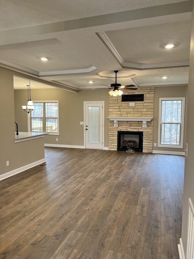 unfurnished living room with dark hardwood / wood-style flooring, a fireplace, a textured ceiling, and ceiling fan with notable chandelier