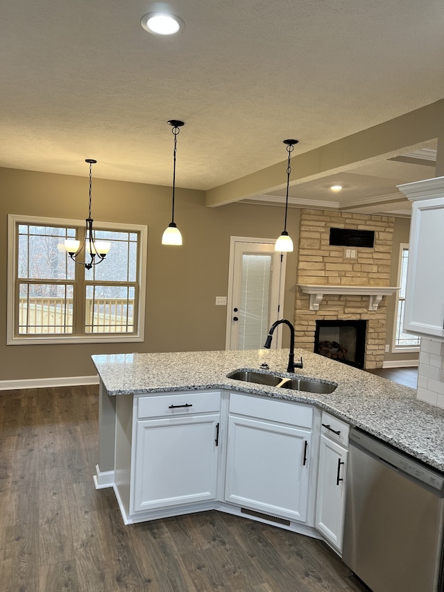 kitchen with dark hardwood / wood-style floors, hanging light fixtures, white cabinets, stainless steel dishwasher, and an inviting chandelier