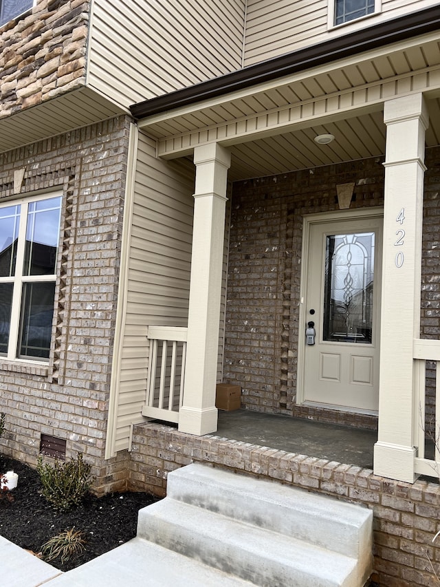 doorway to property featuring covered porch