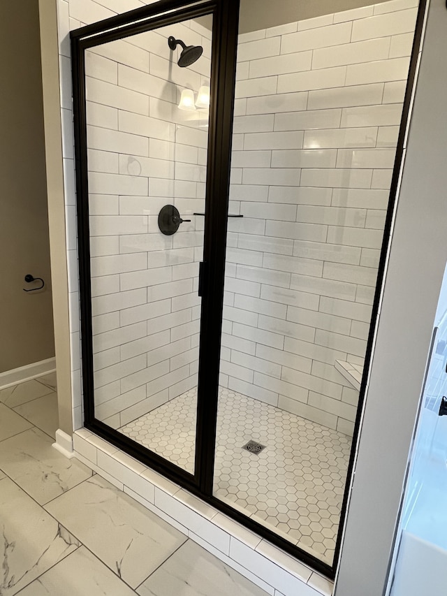 bathroom with tile floors and a shower with shower door