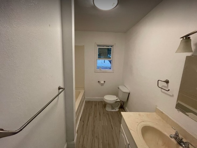 full bathroom featuring tub / shower combination, toilet, vanity, and wood-type flooring