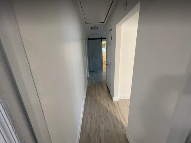 corridor with light hardwood / wood-style floors