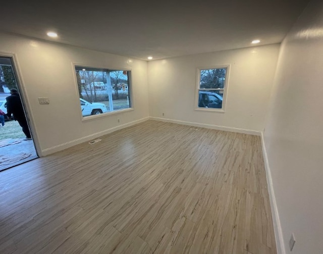 spare room with wood-type flooring