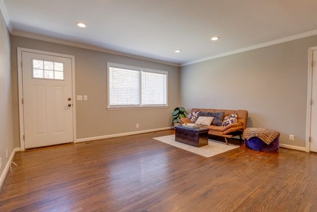 sitting room with ornamental molding and hardwood / wood-style floors