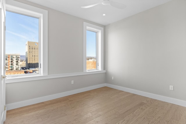 unfurnished room with ceiling fan and light hardwood / wood-style flooring