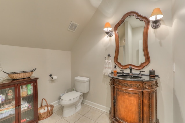 bathroom featuring toilet, tile flooring, vaulted ceiling, and vanity