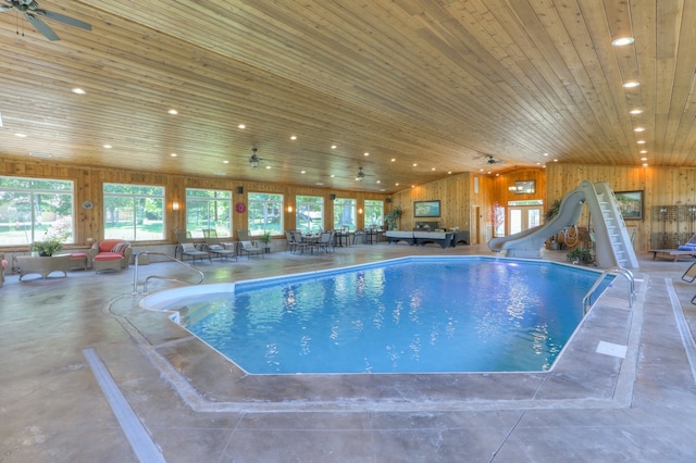 view of pool featuring a water slide and ceiling fan