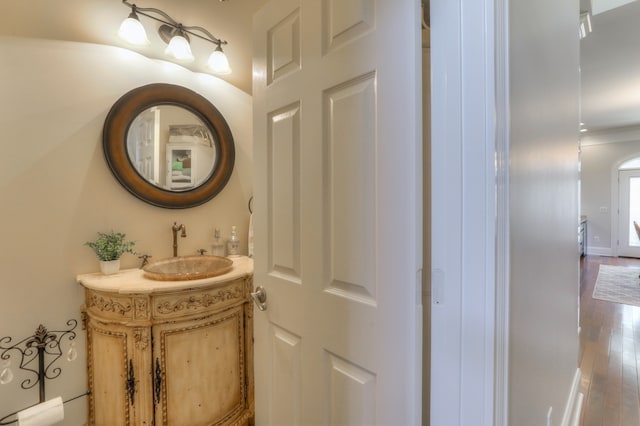 bathroom with oversized vanity and hardwood / wood-style flooring