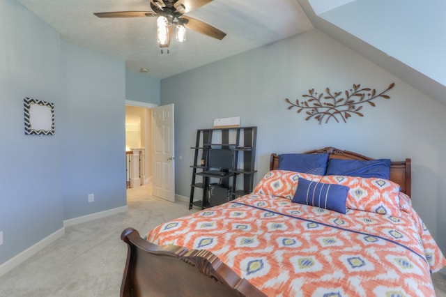 bedroom featuring ceiling fan, lofted ceiling, light colored carpet, and a textured ceiling