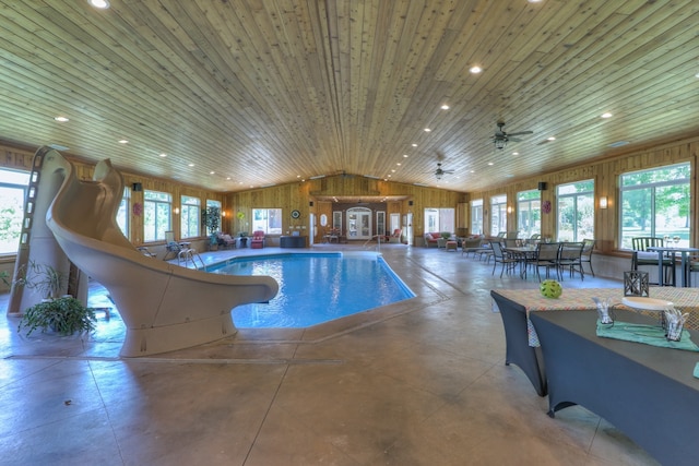 view of swimming pool with ceiling fan and a jacuzzi