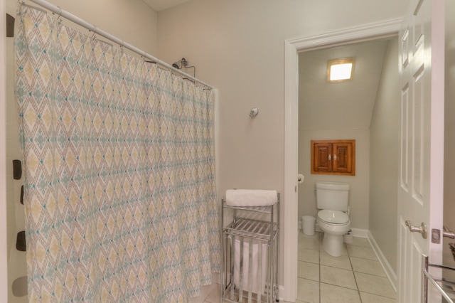 bathroom featuring tile flooring and toilet