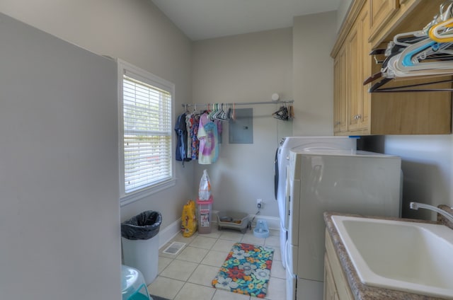 laundry area with cabinets, sink, light tile floors, and independent washer and dryer