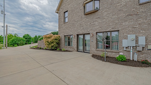 view of side of property with a patio