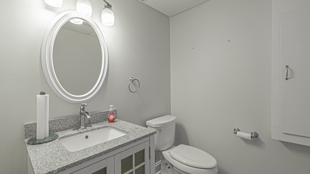 bathroom featuring toilet and vanity